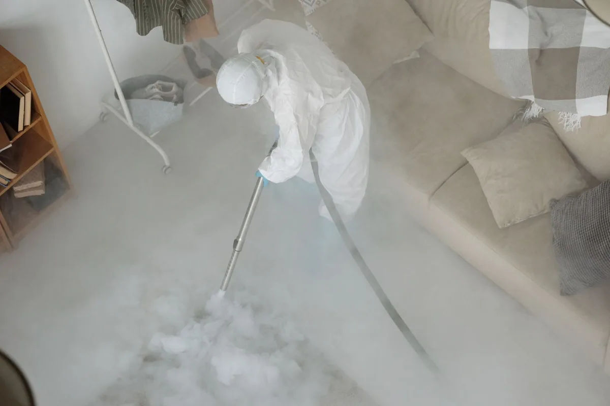 Biohazard cleanup technician in protective equipment, Legacy East, Kansas City, MO